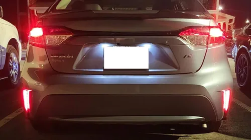 Miniatura 3 de iJDMTOY Luces reflectoras de parachoques LED de lente roja compatibles con Toyota Corolla Sedán 2019-22, funciona como faros antiniebla traseros