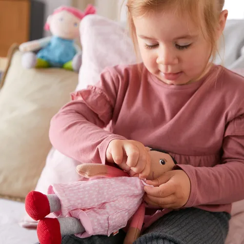 Miniatura 6 de HABA Snug Up Doll Rumbi - Muñeca suave de 10 pulgadas con cabello negro y overol rosa - Lavable a máquina para 18 meses en adelante