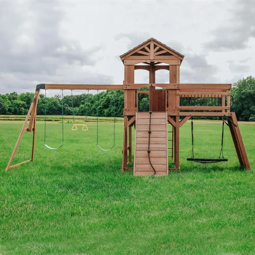 Miniatura 9 de Conjunto de columpios Backyard Discovery Sterling Point de madera de cedro con tobogán de ola, casa club elevada, puente de madera, pared de roca