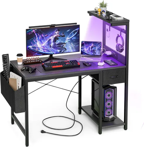 Grandder - Escritorio de juegos de 47 pulgadas con toma de corriente y luz LED, escritorio para computadora con estantes reversibles y cajón de