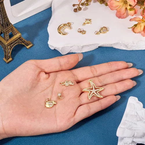 Miniatura 6 de Cheriswelry 8 colgantes chapados en oro de 18 quilates con circonita cúbica, flor, estrella, luna, mariquita, pez, metal, de 0.23 a 0.19 pulgadas