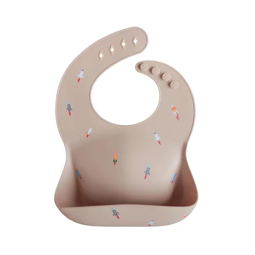 Mushie - Babero de silicón para bebé, ajustable y resistente al agua (cohete)